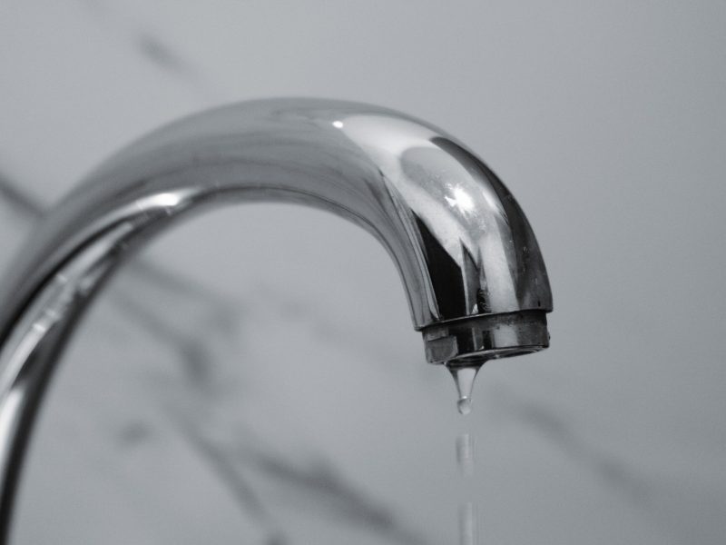 Chrome faucet dripping water